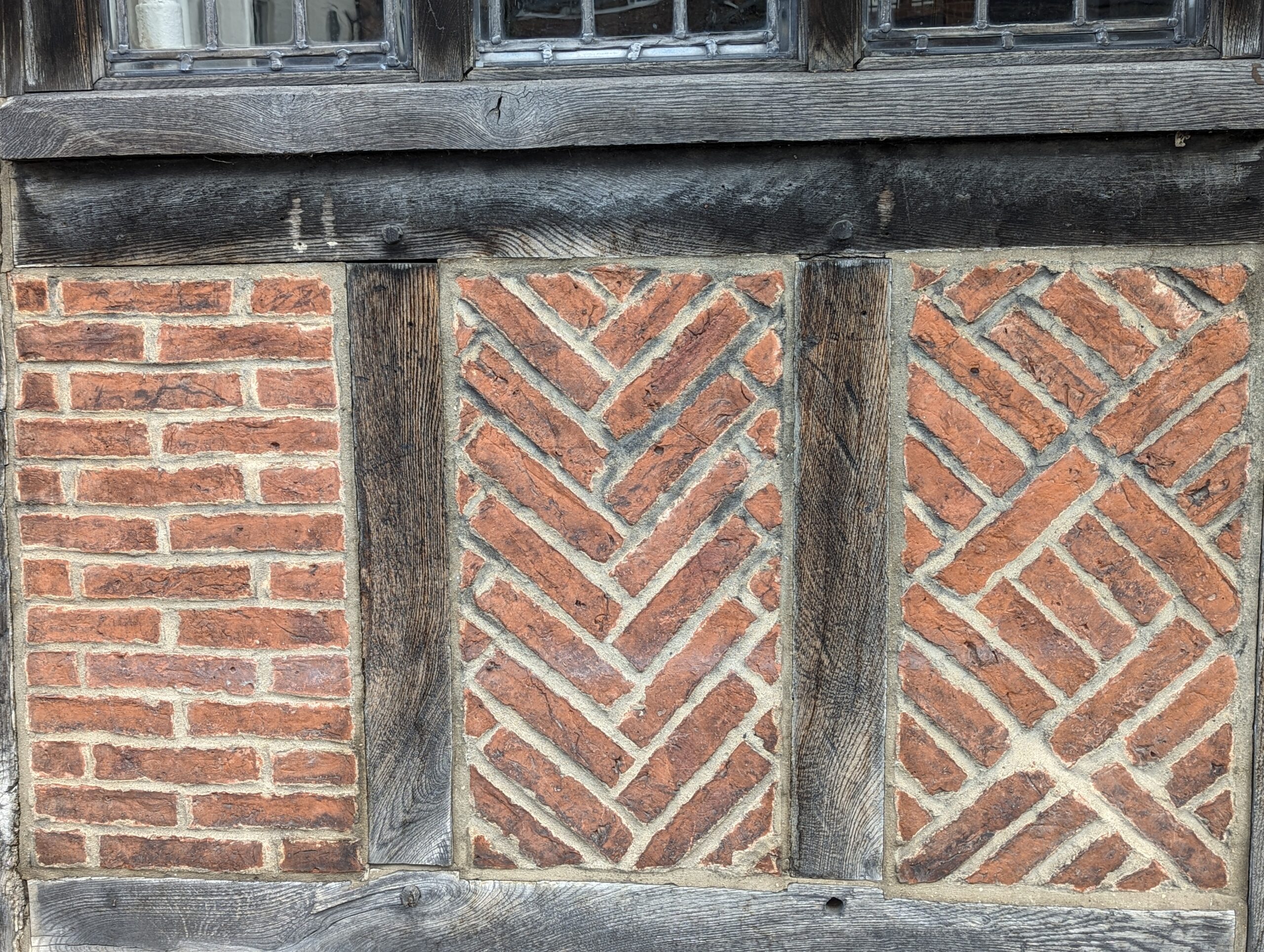 Brick wall with a repeating herringbone pattern