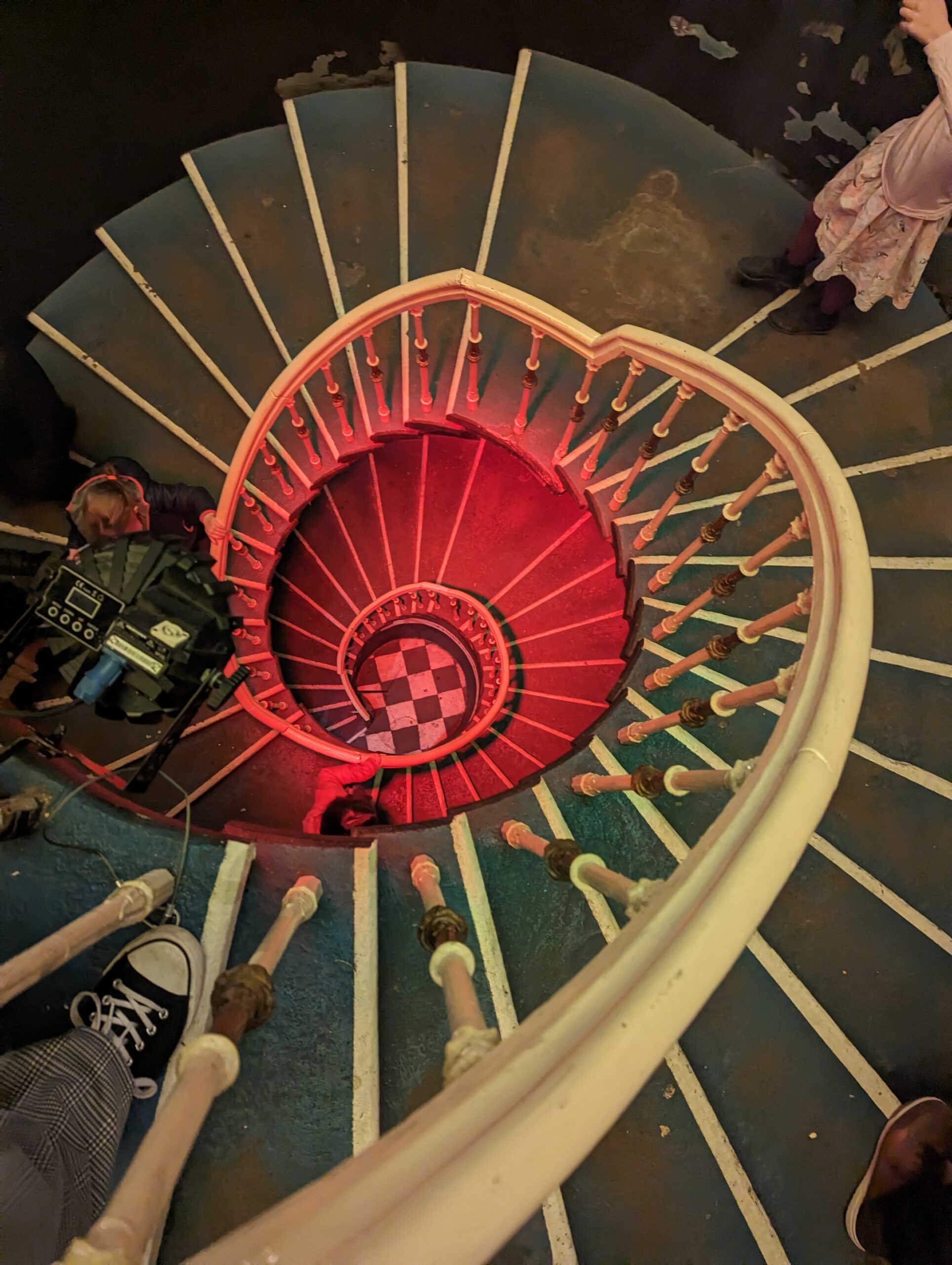 Spiral staircase viewed from above, turning repeatedly around a central point