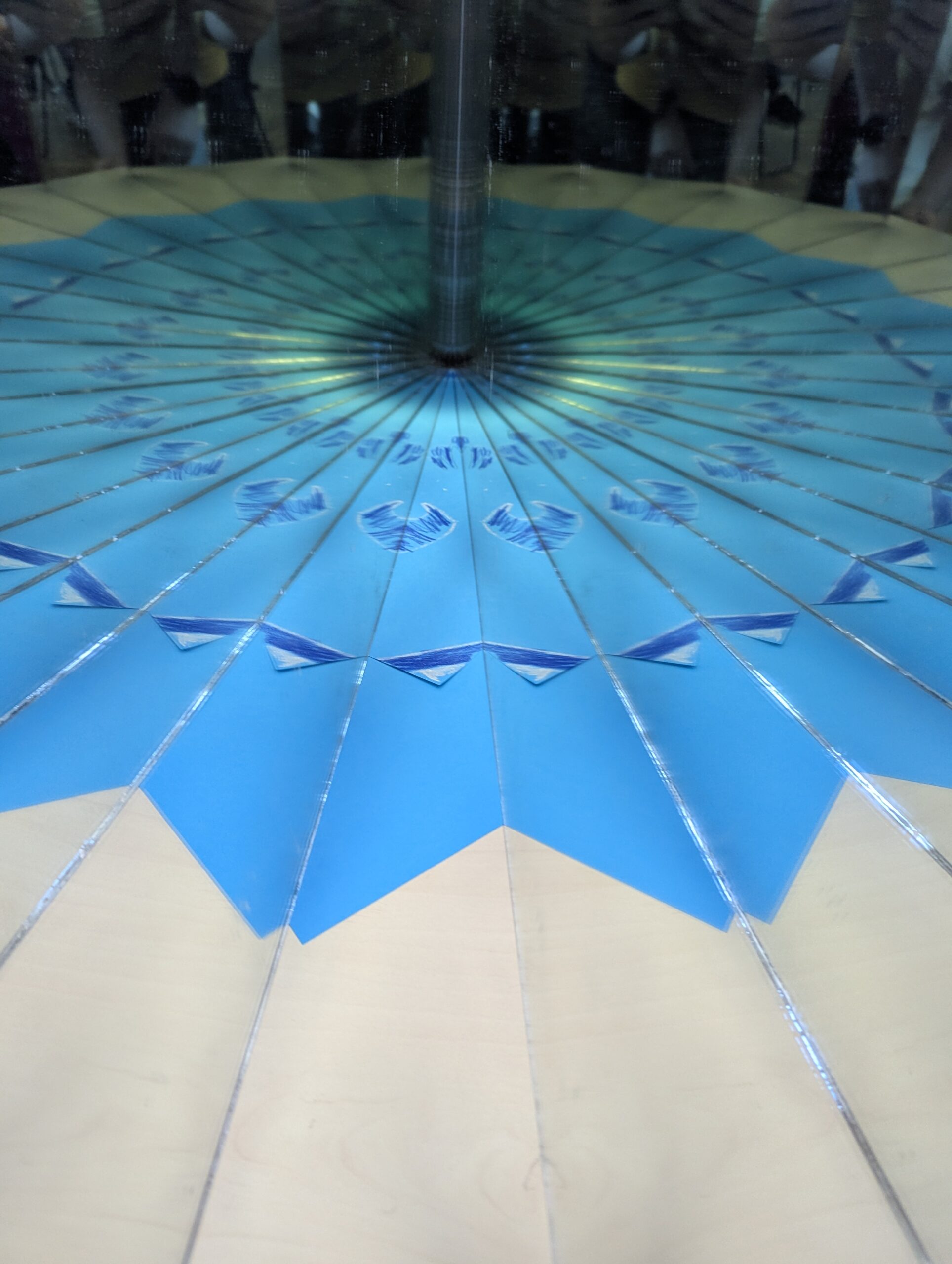 A narrow angle between two mirrors producing many repeated reflections in a blue radial pattern